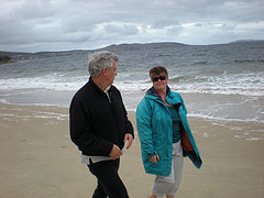 Old couple walking on the shore